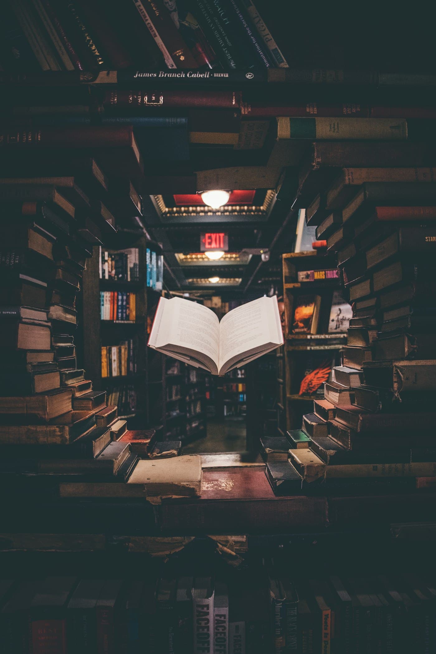Open volume framed by stacked library books